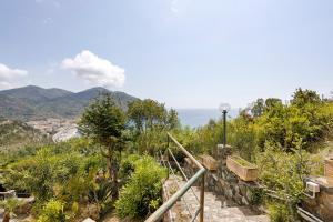 a stairway leading up to a hill with mountains in the background at Juliet in Levanto
