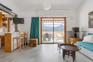 a living room with a bed and a kitchen with a table at Juliet in Levanto
