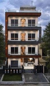 a large white building with a lot of windows at The Glam By Sandane Homes in Greater Noida