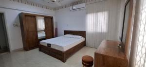a bedroom with a bed and a sink in it at Waterfront in Muscat