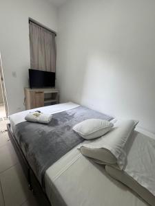 a bedroom with a large bed with two pillows on it at HOTElES SAN ANTONIO in Cali