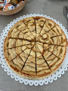 a pie on a white plate on a table at Villa Arneide bed and breakfast in Torre Lapillo