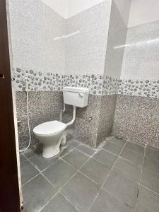 a bathroom with a toilet and a shower at IRCTC Hotel HOSPET in Hospet +9 photos