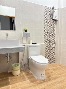 a bathroom with a toilet and a sink and a shower at KlomKlom garden home in Ban Tha Kham +13 photos