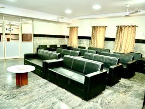 a conference room with green leather chairs and a table at IRCTC Hotel HOSPET in Hospet