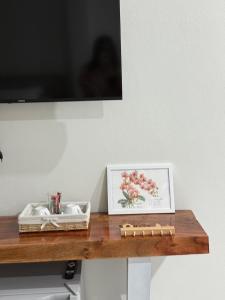a wooden table with a picture on top of it at KlomKlom garden home in Ban Tha Kham