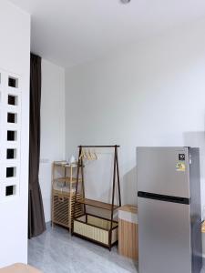 a kitchen with a refrigerator in a room at KlomKlom garden home in Ban Tha Kham