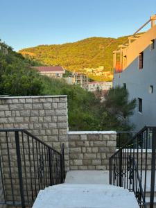 a staircase leading up to a building with a wall at Neva in Budva +4 photos
