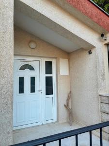 a white door on the side of a house at Neva in Budva