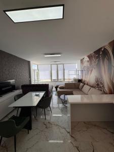 a living room with a couch and a table at Apartman CITY CENTER 9 BAZEN in Prijedor