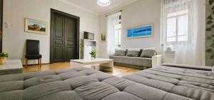 a living room with a bed and a couch at Artist Apartment in Keszthely