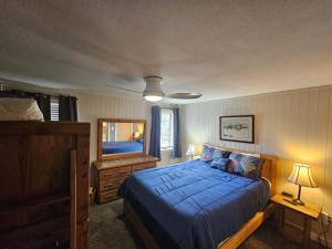 a bedroom with a blue bed and a mirror at Powderidge 42 2 Br: Sleeps 10 in Snowshoe