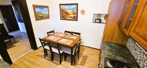 a dining room table and chairs in a room at Artist Apartment in Keszthely