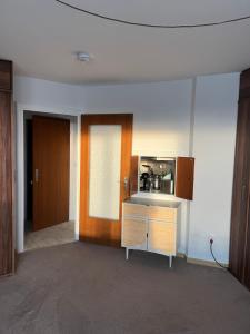 a room with a kitchen with a sink and a door at Sylt Meer in Sylt
