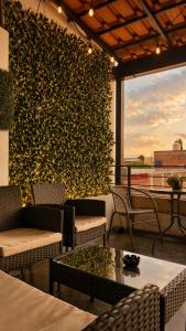 a restaurant with a wall of ivy with tables and chairs at El Suburbio - Morelos Sur in Morelia
