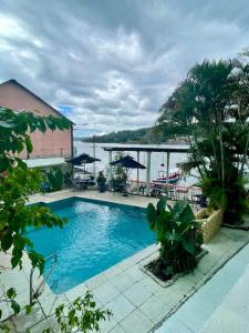 a swimming pool with a view of the water at Hotel Sabana in Flores