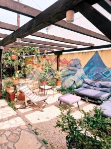 a patio with a couch and a hammock and a mural at Backpackers Home in Zadar