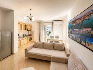 a living room with a couch and a kitchen at H&G Seaview Apartments in Durrës