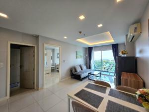 a living room with a couch and a table at One Tower 84 by ThaiminatorPattaya in Pattaya South