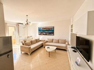 a living room with a couch and a table at H&G Seaview Apartments in Durrës