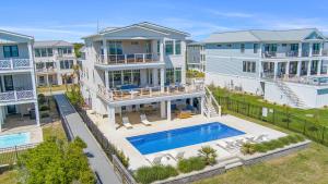an aerial view of a large house with a swimming pool at Roosevelt Oceanfront Escape by Emerald Isle Realty in Pine Knoll Shores