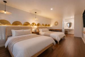 a bedroom with two beds and a mirror at Forest Springs Resort in Eureka Springs