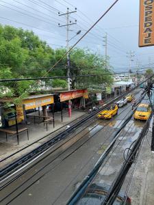 a train station with cars parked next to a street at Hospedaje Antonela in Manta
