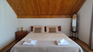 a bedroom with a bed with two white towels on it at Nest for rest in Mojkovac