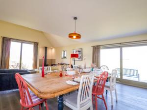 a dining room with a wooden table and chairs at The Mandrel in Tain