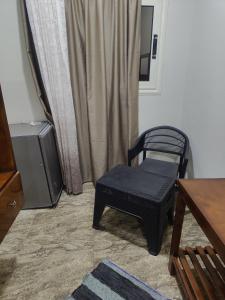a chair and a television in a living room at Nuba Nest in Aswan