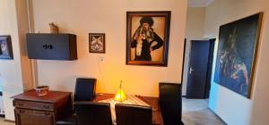 a dining room with a table with a lamp on it at Artist Apartment in Keszthely +84 photos