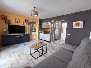 a living room with a couch and a table at Spacious Apartment with 3 pools very central in Benalmádena