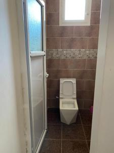 a small bathroom with a toilet and a window at villa larhat vue sur mer in Larhat +21 photos