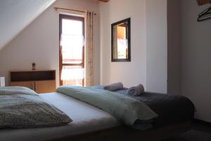a bedroom with a bed with two pillows on it at Vilka Tkáč in Kvačany