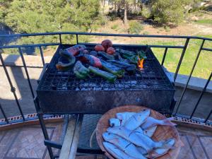 a grill with a bunch of vegetables on it at villa larhat vue sur mer in Larhat