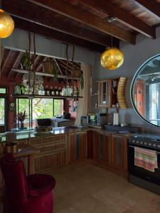 a kitchen with wooden cabinets and a large mirror at La Laguna in Saboga +41 photos