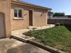 a house with a door and a yard at Marseillan in Marseillan +14 photos
