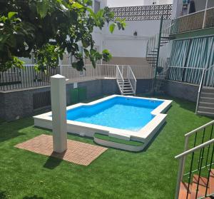 a swimming pool in the middle of a yard at PISO CENTRICO EN PUNTA UMBRIA in Punta Umbría