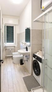 a bathroom with a sink and a washing machine at Modena Station - Suite H24 in Modena +25 photos