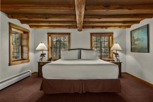 a bedroom with a large white bed and windows at Emerson Resort & Spa in Mount Tremper