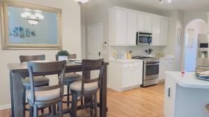 a kitchen with a table and chairs in a room at Dalby Way in Austell