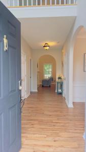 a hallway with a blue door and a couch at Dalby Way in Austell