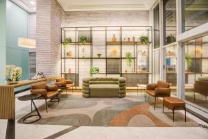 a rendering of a lobby with a couch and chairs at Comfort Ibirapuera in São Paulo +76 photos