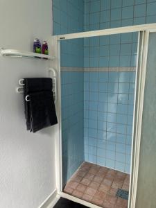 a bathroom with a shower with blue tile at Trevlig lägenhet centralt i Kumla in Kumla