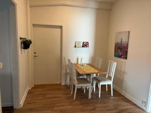 a dining room with a table and chairs at Trevlig lägenhet centralt i Kumla in Kumla +3 photos