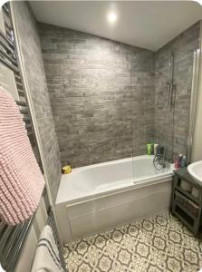 a bathroom with a bath tub and a sink at Big Town Charm in Drogheda +6 photos