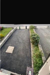an empty parking lot with grass and bushes at Big Town Charm in Drogheda