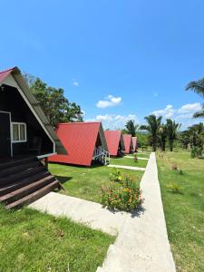 a row of houses with red roofs and flowers at Cabañas Villa Aurora in Campamento