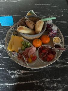 a plate of food with fruits and vegetables on a table at Bed en Breakfast In het Fruit in Zuidoostbeemster +3 photos