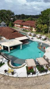 an overhead view of a swimming pool with two tables at Samaúma Park Hotel in Barcarena